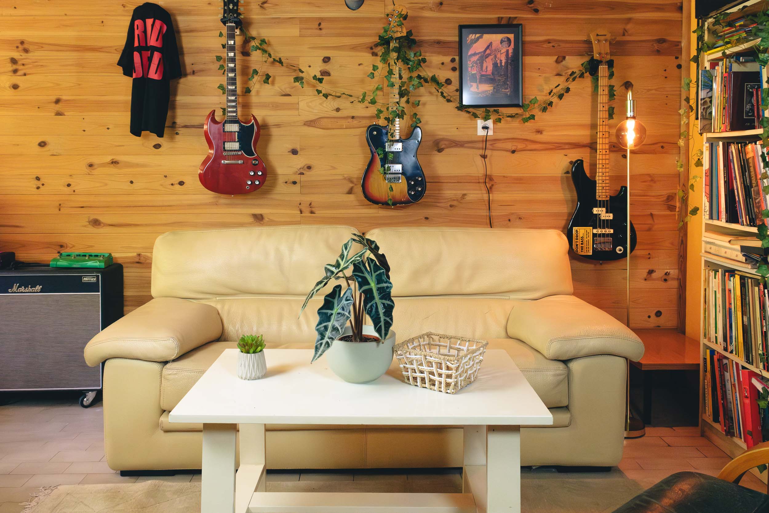 lounge with leather sofa and guitars on the wall